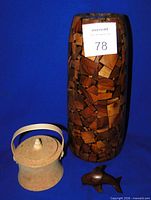 Group shot showing all three items: wood mosaic vase, cork container with lid and handle, ironwood whale