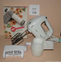 All items grouped: cookie press box, Philips mixer, measuring cups, nut grinder