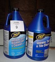 Front view of two Zep 1-gallon cleaner jugs showing labels and fill levels