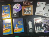 Overview showing multiple Yellow Submarine VHS tapes, DVD-R, loose VHS, Beatles CD box set, Fuji blank VHS and Hard Day’s Night VHS