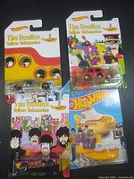 Front view showing all four carded Hot Wheels Beatles cars