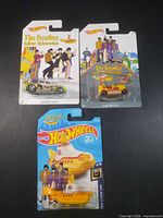 Front view of all three sealed Hot Wheels Beatles Yellow Submarine cars