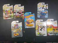 All seven carded Beatles Hot Wheels vehicles displayed together