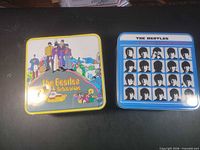 Front view of both Beatles metal tins