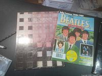 Front covers of Paul McCartney World Tour program and The Beatles Forever magazine