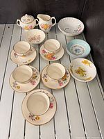 Full layout of tea set and extra bowls on slat surface