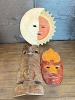 Overview of all three wall masks on wooden surface
