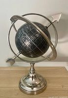Front view of black globe on chrome stand