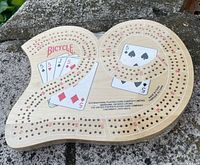 Top view of Bicycle maple burl cribbage board showing pegging track and graphics