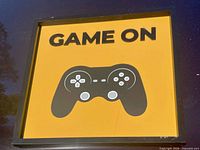 Front view of framed“Game On” controller poster