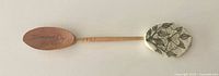 Full view of elk antler spoon showing bowl, handle and floral finial