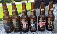 Front view of six Labatt Blue collector bottles showing team logos