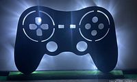 Front view showing illuminated controller silhouette