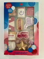 Front view of sealed box showing 12 novelty Costco-themed bath bombs through clear window