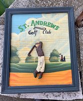 Front view showing St. Andrews Golf Club graphic, carved golfer, frame
