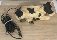 Top view of cow-shaped telephone with attached coiled cord