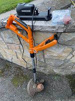 Full view of Worx trimmer with charger, wall mount and spool