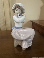Front view of girl with puppy figurine