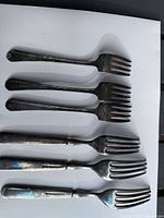 six forks laid out showing full shape