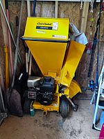 Full view of Cub Cadet CS3310 chipper/shredder showing hopper, engine, wheels, and hitch