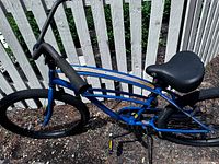 Upper section of blue Hang Ten cruiser showing handlebars, grips, top tube, saddle