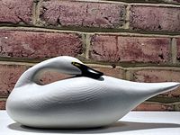 Left-side view of white swan decoy showing overall shape and paint