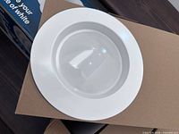 Single LED recessed downlight showing white trim and lens