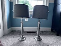 Two matching brushed nickel table lamps with grey shades