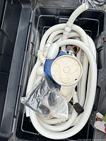 Polaris 360 cleaner body with coiled hoses in bin