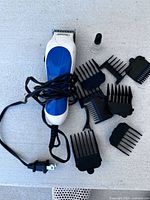 Clipper, power cord, eight comb guides, oil bottle