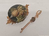 Front view of both brooches side by side