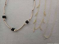 All three necklaces laid flat showing styles and clasps
