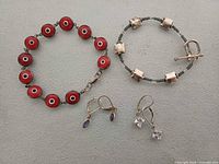 Full view of both bracelets and both pairs of earrings