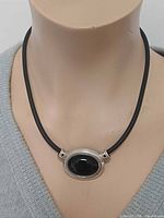 Necklace on mannequin showing pendant front view