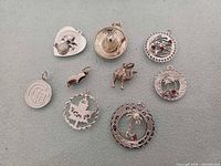 All nine sterling silver charms laid out front view