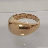 Angled view showing gold tone and 925 mark inside shank