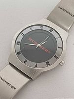 Front view of Hummer wristwatch showing dial, hands, Roman numerals and mesh bracelet