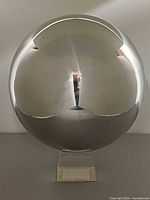 front view of chrome sphere on pedestal