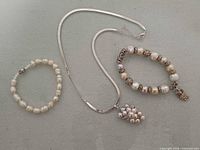 Necklace and two bracelets laid flat