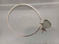 Full view of sterling silver bangle with attached sea-glass and starfish charms