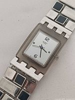 Front view showing dial, case, and bracelet accents