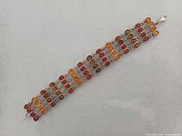 Full view of three-row multicolour amber sterling bracelet