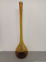 Full view of tall amber glass vase