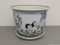 planter front view with saucer showing crane motif