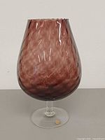 Front view of plum Empoli art glass snifter showing dimple optic bowl and clear stem