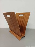 Front angled view of teak V-shaped rack showing wood grain and handle slot