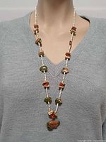 Necklace on mannequin front view showing overall length and arrangement