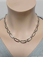 Necklace on mannequin showing front view and link style
