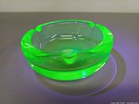Ashtray glowing green under UV light