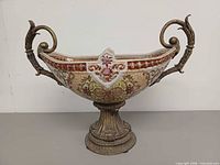 Front view showing entire porcelain bowl, brass handles, and pedestal base